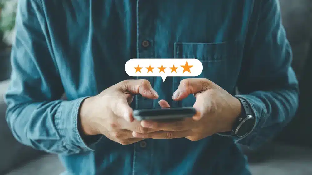 man gives 5 star rating on his phone