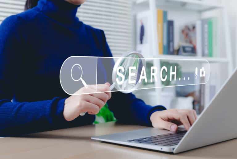 SEO search engine optimization concept. Woman using laptop, holding magnifying glass, symbolizing online search and SEO. Search bar represents internet browsing, keyword analysis, digital marketing,